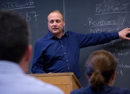 Graduate professor lecturing in front of class