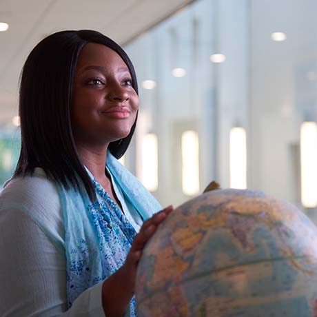 Female student holding globe