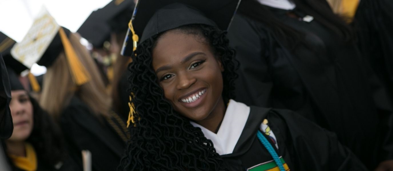 Student smiles at Commencement ceremony