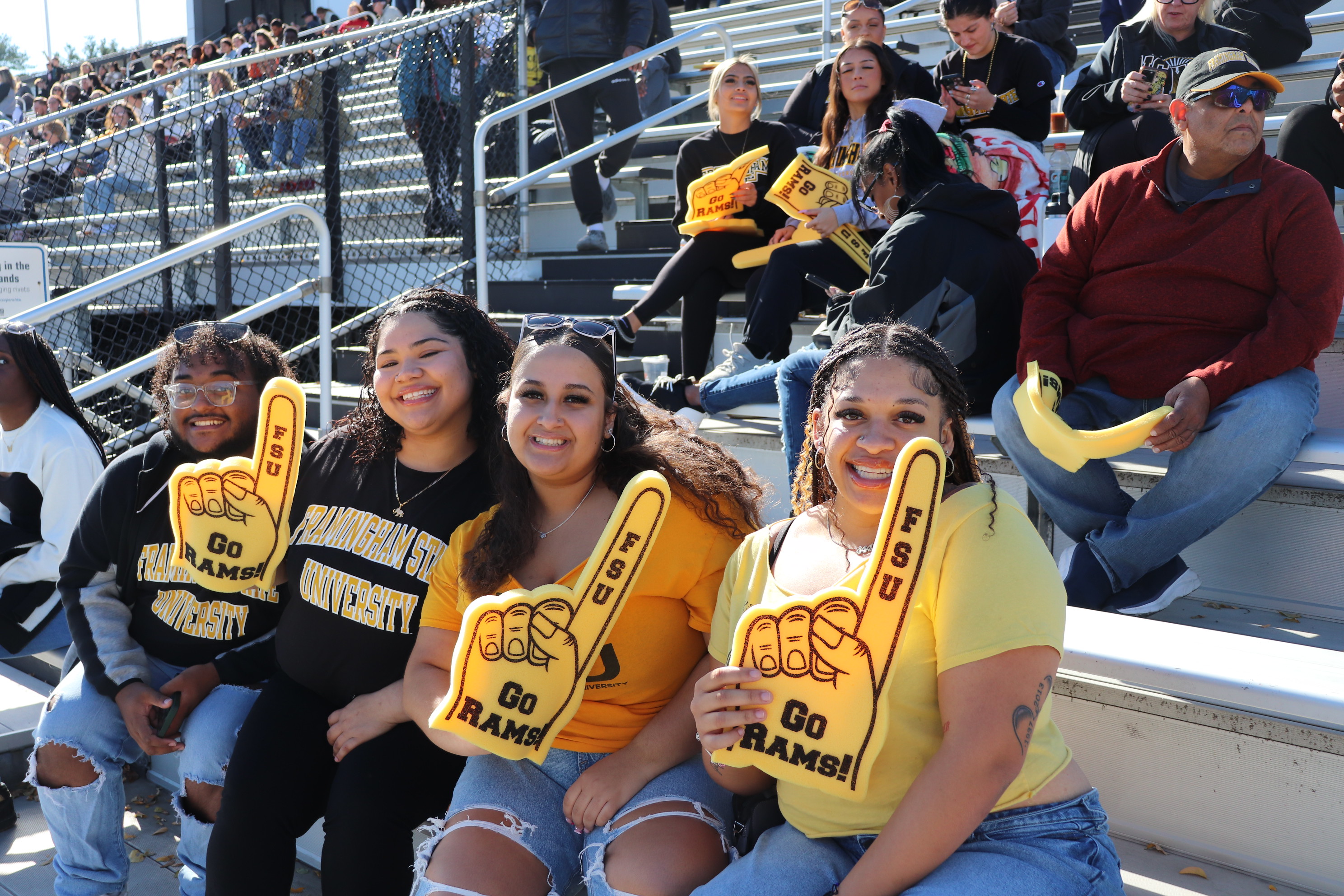 Students at the Football Game holding foam fingers