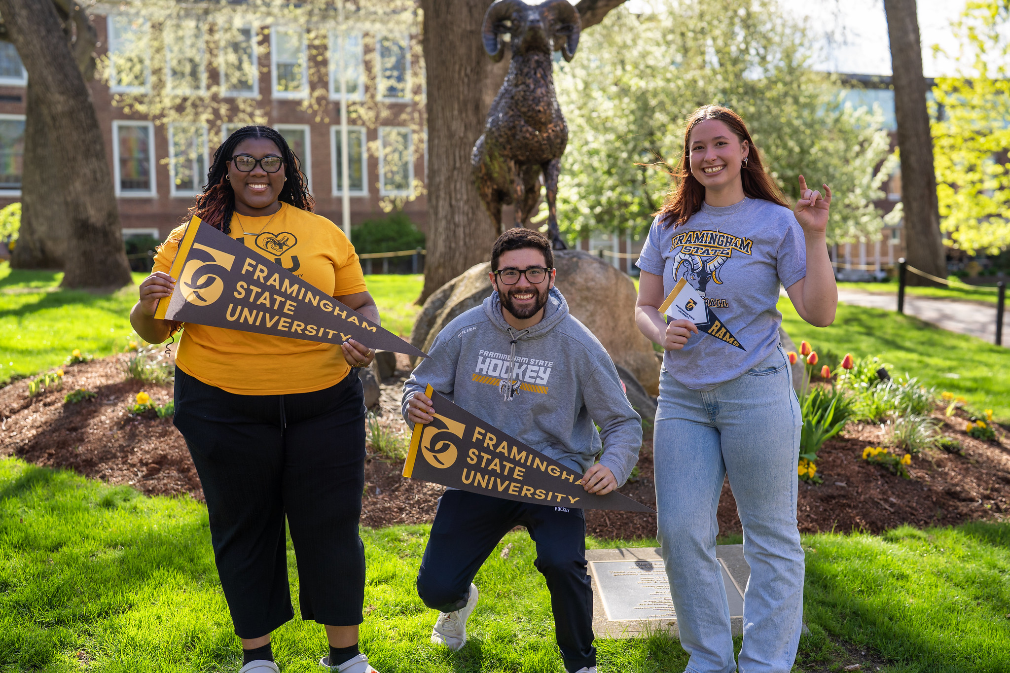 3 Students holding pennants