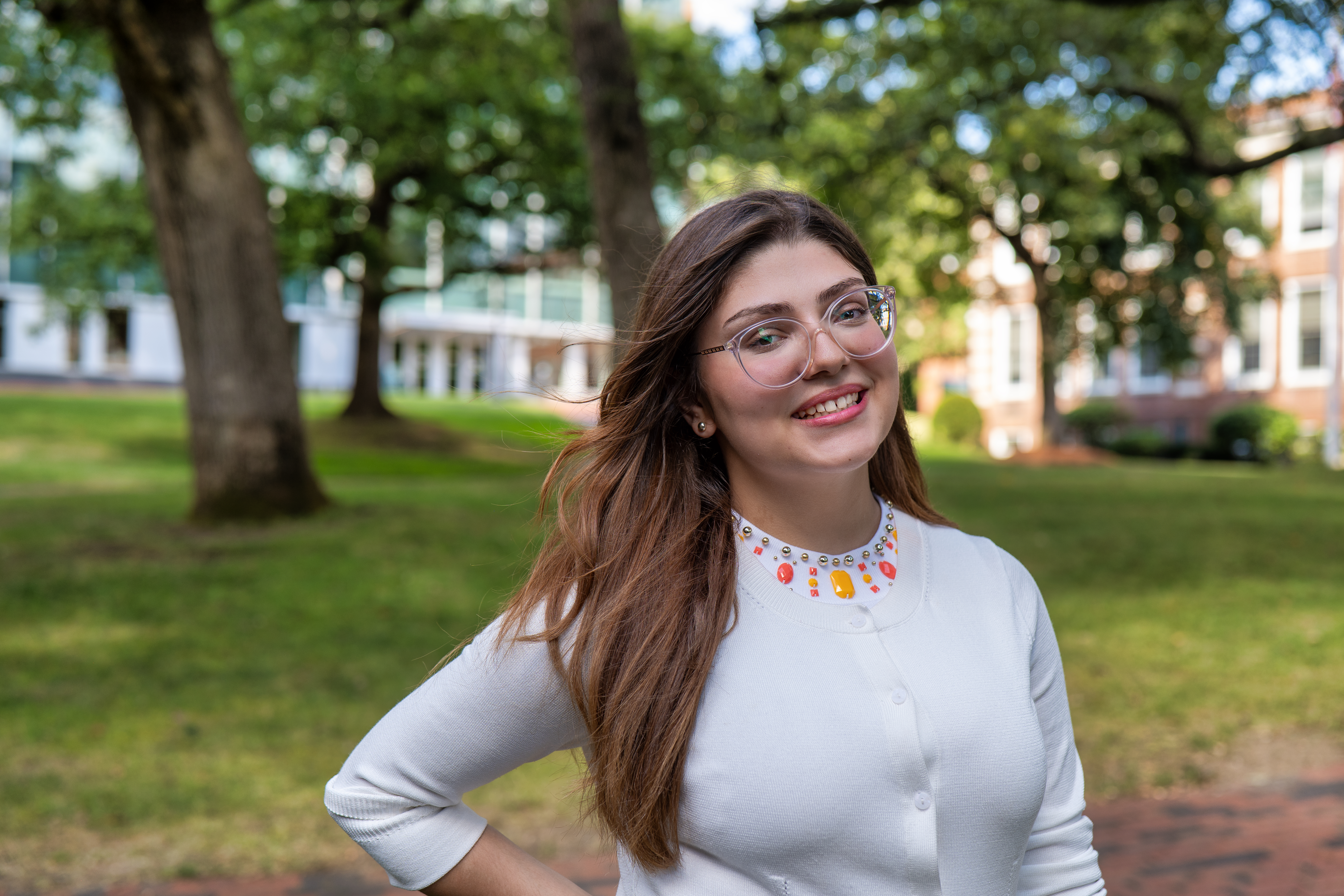 Photo of Ana Julia standing in front of trees and buildings at Framingham State University