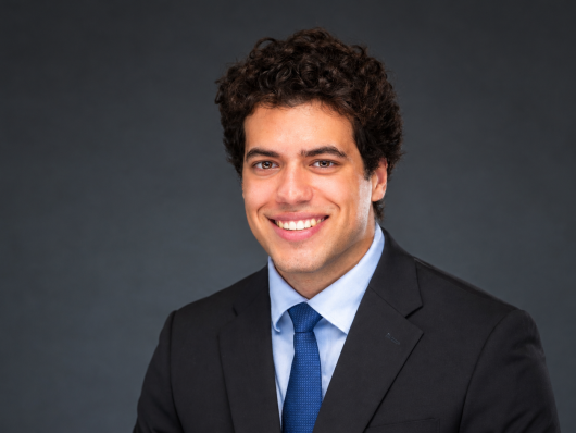 Joshua Reis Soares in a suit with blue tie