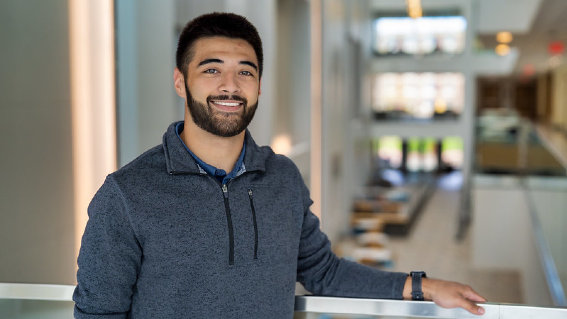 Student smiling with arm draped over