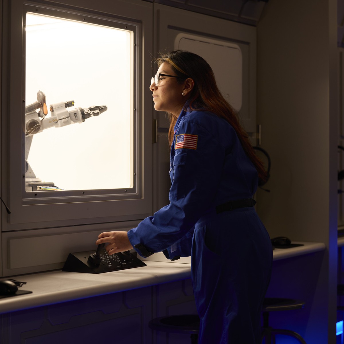 Photo of woman in space jumper at planetarium