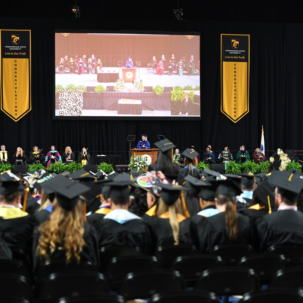 Students looking at the state at commencement 