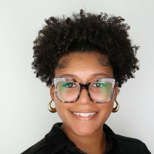 Photo of a smiling woman with glasses