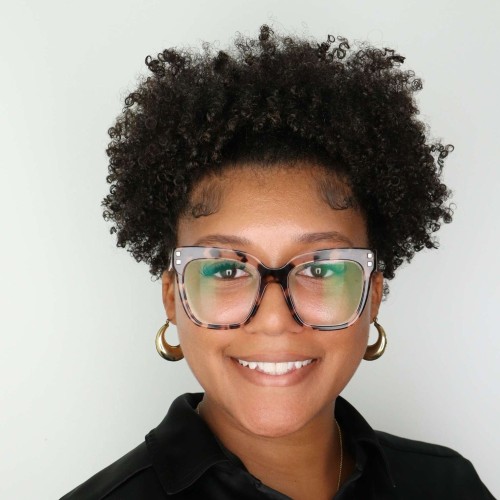 Photo of a smiling woman with glasses