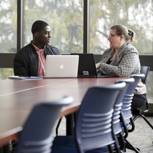 Two people chatting at a table